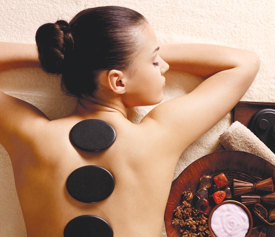 woman having stone massage in spa salon